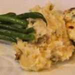 The yummy grouper topped with parmesan and basil served with crisp green beans and garlic taters
