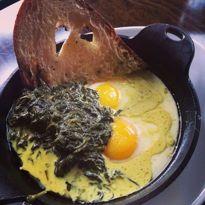 Skillet eggs with creamed spinach and toast.
